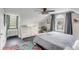Charming attic bedroom with a ceiling fan and large window at 132 Spring St, Charleston, SC 29403