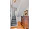 Elegant staircase with hardwood floors and a vintage dresser at 132 Spring St, Charleston, SC 29403