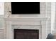 Modern white marble fireplace with a sleek black insert at 1363 Rivella Dr, Mount Pleasant, SC 29464