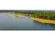 Aerial view of lake with wooded shoreline and walking path at 153 Belfort Pl, Summerville, SC 29486