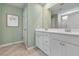 Double vanity bathroom with a large walk in shower and light green walls at 153 Belfort Pl, Summerville, SC 29486