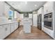 Spacious kitchen boasts white cabinets, stainless steel appliances, and an island at 153 Belfort Pl, Summerville, SC 29486