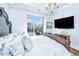Primary bedroom with large bed, hardwood floors, and a wall-mounted TV at 155 Wingo Way # 424, Mount Pleasant, SC 29464