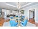 Bright dining area with a glass-top table and blue chairs at 155 Wingo Way # 424, Mount Pleasant, SC 29464