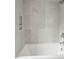 Bathroom with a bathtub and grey tile surround at 1579 E Ashley Ave, Folly Beach, SC 29439