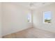 Simple bedroom with hardwood floors and two windows at 1579 E Ashley Ave, Folly Beach, SC 29439