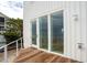 Deck with white siding and double doors opening to the ocean at 1579 E Ashley Ave, Folly Beach, SC 29439