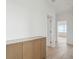 Bright hallway with light wood floors and built-in storage at 1579 E Ashley Ave, Folly Beach, SC 29439