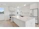 Modern kitchen with white cabinets and marble island at 1579 E Ashley Ave, Folly Beach, SC 29439