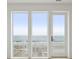Ocean view through large windows from inside the house at 1579 E Ashley Ave, Folly Beach, SC 29439