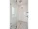 Walk-in shower with glass enclosure and pebble floor at 1579 E Ashley Ave, Folly Beach, SC 29439