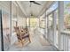 Relaxing screened porch with rocking chairs and ceiling fans at 1879 N James Gregarie Rd, Mount Pleasant, SC 29466