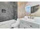 Bathroom boasts a gray tile shower, white vanity, and gold fixtures at 194 Nassau St, Charleston, SC 29403