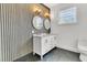 Bathroom features a double vanity, dark wood wall, and gold accents at 194 Nassau St, Charleston, SC 29403