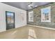 Modern bedroom with dark door, brick accent wall, and hardwood floors at 194 Nassau St, Charleston, SC 29403