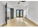 Bedroom with hardwood floors, French doors to backyard, and en-suite bath at 194 Nassau St, Charleston, SC 29403
