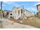Newly renovated light beige house with white steps and a real estate sign at 194 Nassau St, Charleston, SC 29403