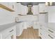 Modern kitchen with white cabinets, quartz countertops and gold hardware at 194 Nassau St, Charleston, SC 29403