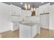 Modern kitchen with white cabinets, quartz countertops, and a statement range hood at 194 Nassau St, Charleston, SC 29403