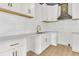 Modern kitchen with white cabinets, quartz countertops and gold hardware at 194 Nassau St, Charleston, SC 29403