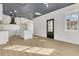 Modern kitchen with white cabinets, quartz countertops and island, and gold accents at 194 Nassau St, Charleston, SC 29403
