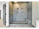 Spacious walk-in shower with gray tile and gold fixtures at 194 Nassau St, Charleston, SC 29403