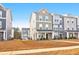 Three-story townhome with neutral siding and landscaping at 352 Herty Park Dr, Moncks Corner, SC 29461