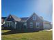 Two-story craftsman style home with stone accents and a landscaped lawn at 219 Darby Meadow Ln, Ridgeville, SC 29472