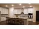 Modern kitchen with white cabinets, large island, and stainless steel appliances at 219 Darby Meadow Ln, Ridgeville, SC 29472