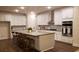 Modern kitchen with white cabinets, large island, and stainless steel appliances at 219 Darby Meadow Ln, Ridgeville, SC 29472