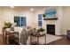 Spacious living room with fireplace, hardwood floors, and large windows at 219 Darby Meadow Ln, Ridgeville, SC 29472