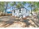 White house exterior with a backyard and trees at 2208 Bailey Dr, North Charleston, SC 29405