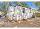 Side view of a white house with a backyard and trees at 2208 Bailey Dr, North Charleston, SC 29405