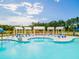 Relaxing pool area with lounge chairs and umbrellas near cabanas at 252 Watersglen Way, Summerville, SC 29486