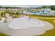 Community splash pad with a unique design, surrounded by sandy play area at 252 Watersglen Way, Summerville, SC 29486
