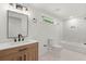 Modern bathroom with a light wood vanity, marble shower, and bathtub at 31 Allway St, Charleston, SC 29403