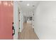 Bright entryway with coral door and view into the open concept living area and kitchen at 31 Allway St, Charleston, SC 29403