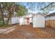 White house exterior with a coral door and wooden fence at 31 Allway St, Charleston, SC 29403