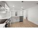 Open concept kitchen with white cabinets, island, stainless steel appliances, and a view of the entryway at 31 Allway St, Charleston, SC 29403