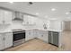 Open concept kitchen with white cabinets, stainless steel appliances, and a farmhouse sink at 31 Allway St, Charleston, SC 29403