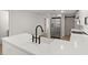 Modern kitchen boasts white shaker cabinets, quartz countertops, and stainless steel appliances at 31 Allway St, Charleston, SC 29403