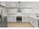 Modern kitchen with white cabinets, stainless steel appliances, and quartz countertops at 31 Allway St, Charleston, SC 29403