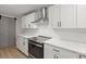 Modern kitchen with white cabinets, stainless steel appliances and a farmhouse sink at 31 Allway St, Charleston, SC 29403
