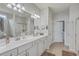 Double vanity bathroom with a walk-in shower and access to a walk-in closet at 506 Tranquil Waters Way, Summerville, SC 29486