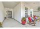 Inviting front porch with rocking chairs, creating a relaxing atmosphere at 506 Tranquil Waters Way, Summerville, SC 29486