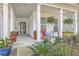 Inviting front porch with rocking chairs and potted plants at 506 Tranquil Waters Way, Summerville, SC 29486