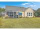 Home with a screened porch and grassy backyard at 506 Tranquil Waters Way, Summerville, SC 29486