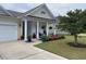 Charming home with a front porch and landscaping at 506 Tranquil Waters Way, Summerville, SC 29486