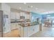 Spacious kitchen boasts white cabinets, granite island, and stainless steel appliances at 506 Tranquil Waters Way, Summerville, SC 29486