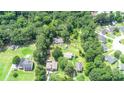 Aerial image showcasing a neighborhood surrounded by trees at 1633 Rose Dr, Summerville, SC 29486